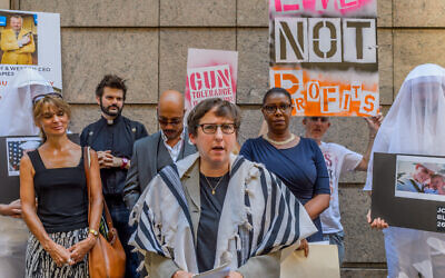 Rabbi Sharon Kleinbaum of Congregation Beth Simchat Torah joined others at a 2016 press conference condemning the appearance of Smith & Wesson's CEO at a conference. (Erik McGregor/LightRocket via Getty Images/JTA)