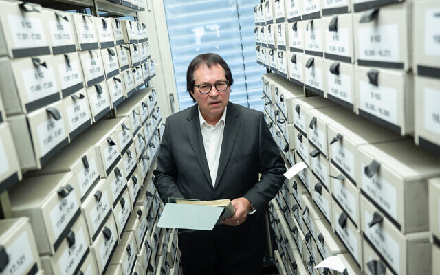 Senior Public Prosecutor Thomas Will, head of the Central Office of the State Justice Administrations for the Investigation of National Socialist Crimes, stands among the files used for the work of the Central Office at the branch office of the Federal Archives in Ludwigsburg. (Sebastian Gollnow/picture alliance via Getty Images via JTA) Senior Public Prosecutor Thomas Will, head of the Central Office of the State Justice Administrations for the Investigation of National Socialist Crimes, stands among the files used for the work of the Central Office at the branch office of the Federal Archives in Ludwigsburg. (Sebastian Gollnow/picture alliance via Getty Images via JTA)