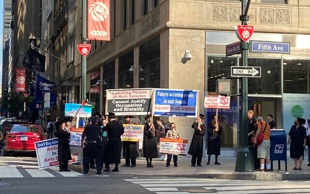 Anti-Israel Neturei Karta activists protest across the street from pro-Israel demonstrators in Manhattan on August 12, 2021. (Jacob Magid/Times of Israel)