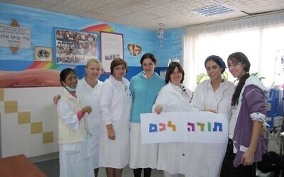 Laniado Staff holding a thank you sign following the publication of the survey