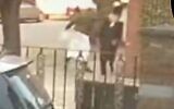 A man in traditional Muslim garb is seen punching an ultra-Orthodox man in the street, in the heavily-Jewish neighborhood of Stamford Hill. (Screenshot/Twitter)