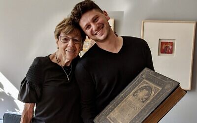 Susi Kasper Leiter and Jacob Leiter hold family bible, August 12, 2021. (Jacob Leiter/Courtesy)
