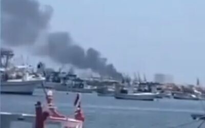 Smoke billows from a ship at the Latakia harbor in Syria, following a reported explosion, August 10, 2021. (Screenshot: Twitter)