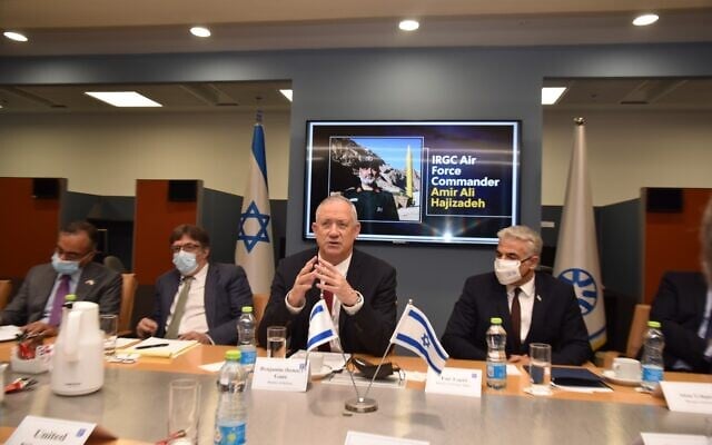 Defense Minister Benny Gantz (C) and Foreign Minister Yair Lapid (R) addressing foreign ambassadors at the Foreign Ministry, August 4, 2021. (Israel Foreign Ministry