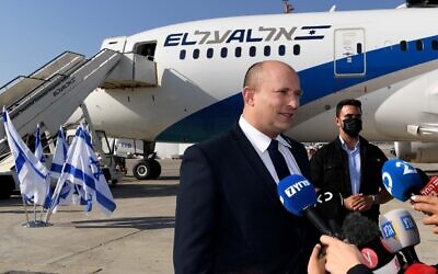 Prime Minister Naftali Bennett speaks to reporters before departing Ben Gurion Airport for Washington on August 24, 2021 (Avi Ohayon/GPO)