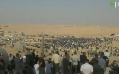 Thousands of mourners turn out for the funeral of Ra'am MK Said al-Harumi in Segev Shalom, on August 25, 2021. (Screenshot/Kan)