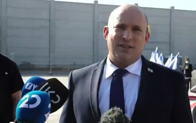 Prime Minister Naftali Bennett speaks to reporters at Ben Gurion Airport before flying to Washington, on August 24, 2021 (Channel 12 screenshot)
