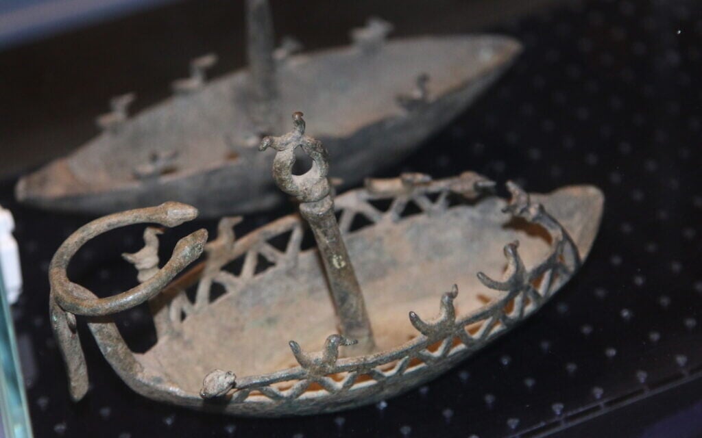 An ancient model boat with birds on the sides, on display at the Bible Lands Museum's exhibit 'Early Birds.' (Shmuel Bar-Am)