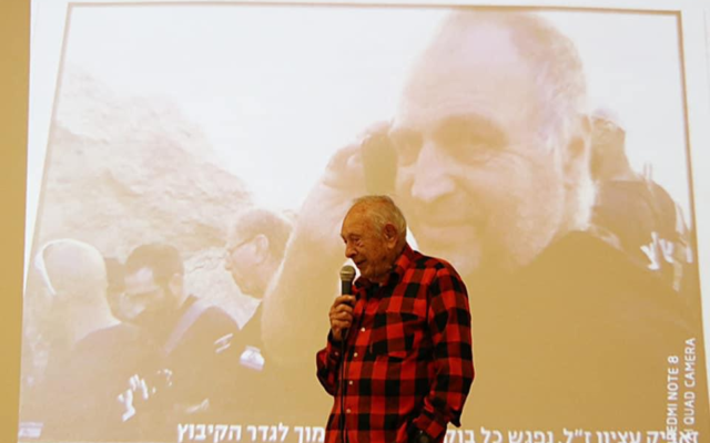 Moshe Etzion speaks before an image of his son, Ze'ev Etzion, who died from Gaza rocket fire in 2014. (Eshkol Regional Council)