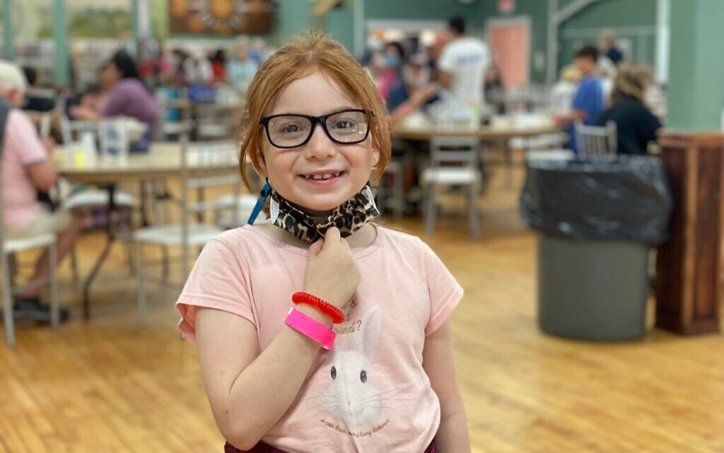 8-year-old Dinah Slepovitch has greeted Yiddishland attendees each morning for the last five years, and continues to do so in August 2021. (Danielle Ziri)