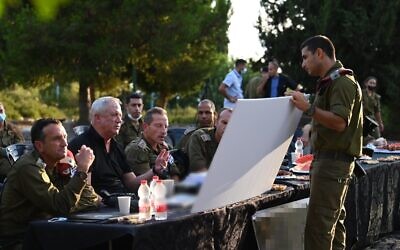 Defense Minister Benny Gantz speaks with military officials in the IDF northern command, on August 10, 2021. (Ariel Hermoni/Defense Ministry)