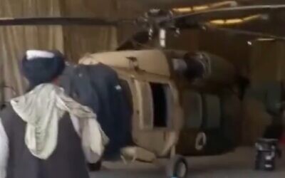 Taliban show off US-made Afghan military helicopters captured at Kandahar Airport, screen grab from video uploaded to Twitter on August 14, 2021.