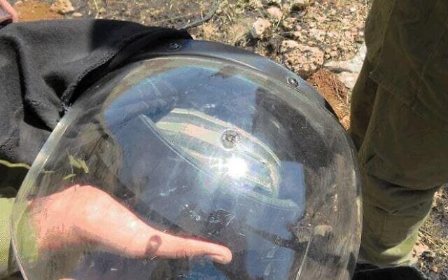 A bullet hole is seen on the helmet of an IDF soldier, who was shot at while responding to a violent protest near Hebron in the West Bank May 12, 2021. (Shin Bet) A bullet hole is seen on the helmet of an IDF soldier, who was shot at while responding to a violent protest near Hebron in the West Bank May 12, 2021. (Shin Bet)