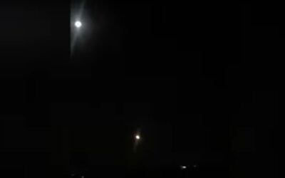 An air defense missile, bottom center, streaks toward what appears to be a missile shot into Syria, in a video distributed by Syrian state news. (Screen capture: YouTube/SANA)