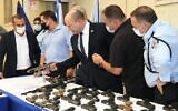 Prime Minister Naftali Bennett (center) visits a police station on August 11, 2021, to announce a new national plan to tackle crime in the Arab sector. (Amos Ben-Gershom/GPO)