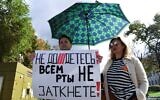 A woman holds a placard reading "You can't shut up everyone!" as journalists and supporters take part in a protest against the list of "foreign agent" media in central Moscow on September 4, 2021. (Natalia KOLESNIKOVA / AFP)
