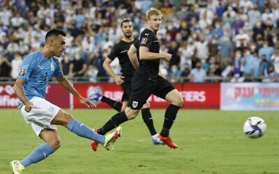 Israel's forward Eran Zahavi (L) shoots to score the third goal during the 2022 Qatar World Cup European Qualifiers football match between Israel and Austria at the Sammy Ofer Stadium in Haifa, on September 4, 2021. (JACK GUEZ / AFP)
