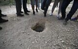 Police and journalists gather around a hole used by six Palestinians to escape from the Gilboa Prison, in northern Israel, on September 6, 2021. (Jalaa Marey/AFP)