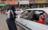 Supporters of the Islamic Jihad movement distribute sweets to celebrate the escape of six Palestinians from an Israeli prison, in Rafah in the southern Gaza Strip, on September 6, 2021. (Said Khatib/AFP)