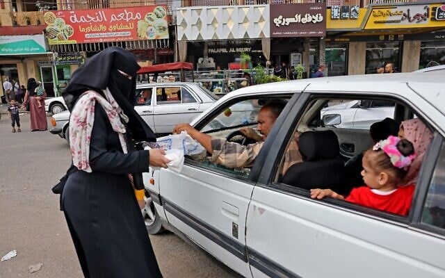 Supporters of the Islamic Jihad movement distribute sweets to celebrate the escape of six Palestinians from an Israeli prison, in Rafah in the southern Gaza Strip, on September 6, 2021. (Said Khatib/AFP) Supporters of the Islamic Jihad movement distribute sweets to celebrate the escape of six Palestinians from an Israeli prison, in Rafah in the southern Gaza Strip, on September 6, 2021. (Said Khatib/AFP)