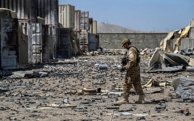 A member of the Taliban Badri 313 military unit walks amid debris of the destroyed Central Intelligence Agency (CIA) base in Deh Sabz district northeast of Kabul on September 6, 2021 after the US pulled all its troops out of the country. (Photo by Aamir QURESHI / AFP)
