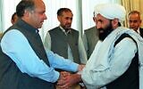 In this photo from August 26, 1999, Pakistani Prime Minister Nawaz Sharif receives Afghan Foreign Minister Mullah Mohammad Hassan Akhund (right) in Islamabad. The Taliban announced Mullah Mohammad Hasan Akhund as the leader of their new government in Afghanistan on September 7, 2021. (SAEED KHAN / AFP)