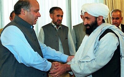 In this photo from August 26, 1999, Pakistani Prime Minister Nawaz Sharif receives Afghan Foreign Minister Mullah Mohammad Hassan Akhund (right) in Islamabad. The Taliban announced Mullah Mohammad Hasan Akhund as the leader of their new government in Afghanistan on September 7, 2021. (SAEED KHAN / AFP)