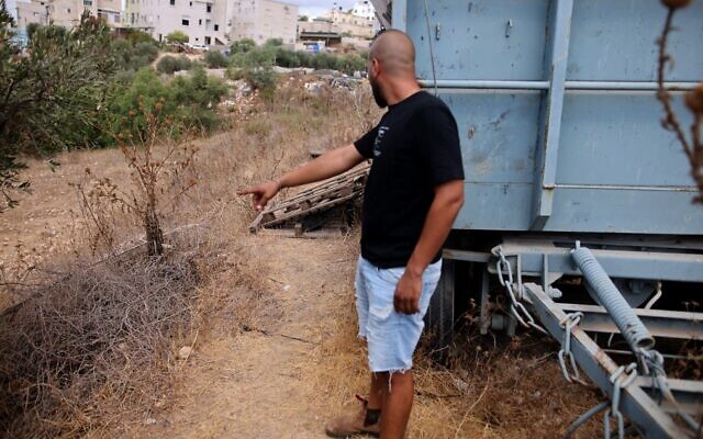 A man points at the spot where an escaped Palestinian security prisoner  was recaptured in the northern Arab town of Shibli–Umm al-Ghanam on September 11, 2021. (Ahmad Gharabli/AFP)