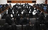 Veiled students hold Taliban flags as they listen a speaker before a pro-Taliban rally at the Shaheed Rabbani Education University in Kabul on September 11, 2021. (Aamir QURESHI / AFP)