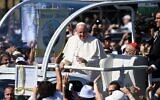 Pope Francis greets faithful as he arrives in an open vehicle for a Holy Mass at the end of an International Eucharistic Congress in Budapest on September 12, 2021, during his papal visit to Hungary. (Attila KISBENEDEK / AFP)