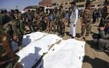 A Yemeni soldier takes a selfie as others surround body bags containing the corpses of newly executed men, convicted of involvement in the assassination of Houthi political leader Saleh al-Sammad three years ago, at a public square in the Yemeni capital Sanaa, on September 18, 2021. (Mohammed Huwais/AFP)
