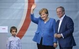 Christian Democratic Union CDU leader and chancellor candidate Armin Laschet (R) and German Chancellor Angela Merkel react on stage during their campaign rally in Aachen, western Germany, on September 25, 2021, one day ahead of the German federal elections. (Ina Fassbender / AFP)