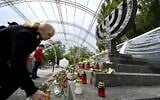 People light candles at Minora memorial in Kyiv, on September 29, 2021, on the 80th anniversary of the Babi Yar massacre, one of the largest mass slaughters of Jews during World War II. (Sergei Supinsky/AFP)