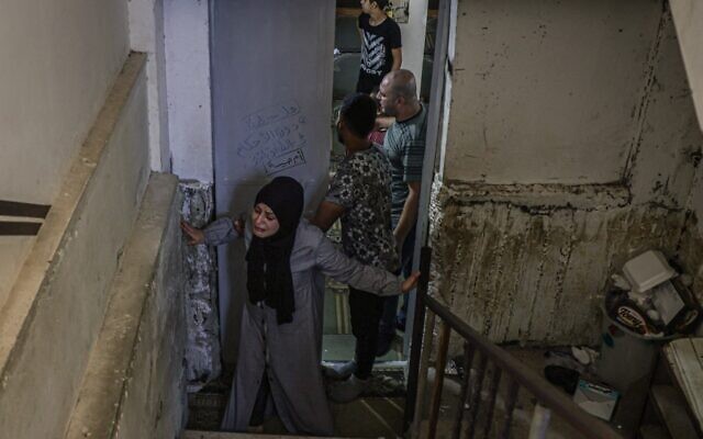 A relative mourns the death of Palestinian Mohammad Abu Ammar, 40, killed by Israeli troops near the separation fence with Israel, during his funeral in the refugee camp of Bureij, in the Gaza Strip, on September 30, 2021. (Mohammed Abed/AFP) A relative mourns the death of Palestinian Mohammad Abu Ammar, 40, killed by Israeli troops near the separation fence with Israel, during his funeral in the refugee camp of Bureij, in the Gaza Strip, on September 30, 2021. (Mohammed Abed/AFP)