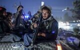 Members of the Taliban patrol on a pickup truck in Kabul, on September 30, 2021. (Bulent Kilic/AFP)