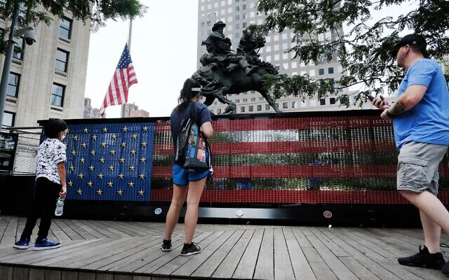 People visit a monument made of dog tags of fallen US troops from the Global War on Terror at Liberty Park on the World Trade Center campus in New York City, August 31, 2021. (Spencer Platt/Getty Images/AFP) People visit a monument made of dog tags of fallen US troops from the Global War on Terror at Liberty Park on the World Trade Center campus in New York City, August 31, 2021. (Spencer Platt/Getty Images/AFP)