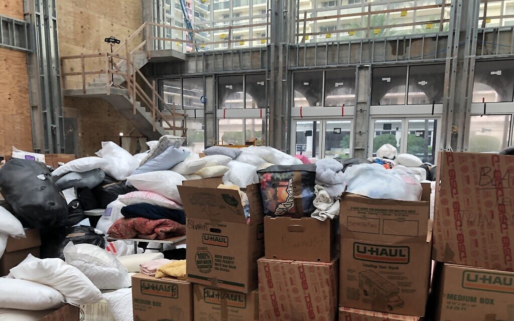 A social hall under construction in The Shul, a synagogue in Surfside, Florida, is piled high with donations for homeless families less than 18 hours after a nearby building collapsed, June 25, 2021. (Ron Kampeas/ JTA)