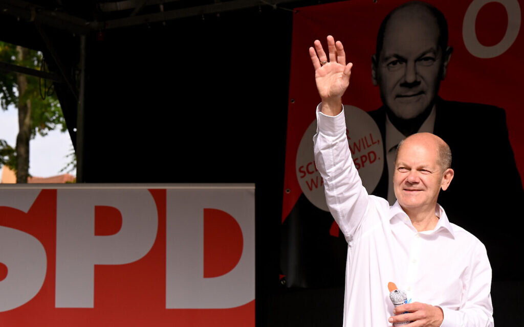 Olaf Scholz (M), Finance Minister and SPD candidate for Chancellor, waves to his audience and supporters during a campaign event at Schillerplatz in Nürtingen. (Bernd Weißbrod/picture alliance via Getty Images via JTA) Olaf Scholz (M), Finance Minister and SPD candidate for Chancellor, waves to his audience and supporters during a campaign event at Schillerplatz in Nürtingen. (Bernd Weißbrod/picture alliance via Getty Images via JTA)