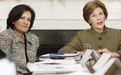 Anita McBride, left, Chief of Staff to first lady Laura Bush, right, looks on as Mrs. Bush makes opening remarks during a video teleconference in the Roosevelt Room of the White House in Washington, Monday, Dec. 10, 2007. (AP Photo/Charles Dharapak)