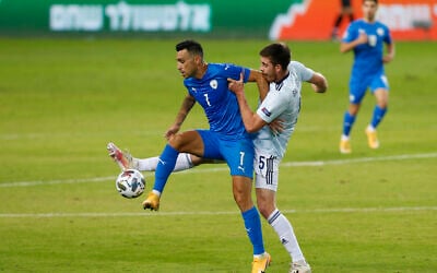 Illustrative: Eran Zahavi, left, and Scotland's Declan Gallagher fight for the ball during the UEFA Nations League soccer match between Israel and Scotland in Netanya, Israel, Wednesday, Nov. 18, 2020. (AP Photo/Ariel Schalit)