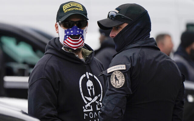 People wearing hats and patches indicating they are part of Oath Keepers attend a rally at Freedom Plaza, on January 5, 2021, in Washington, DC, in support of then-US President Donald Trump. (AP Photo/Jacquelyn Martin) People wearing hats and patches indicating they are part of Oath Keepers attend a rally at Freedom Plaza, on January 5, 2021, in Washington, DC, in support of then-US President Donald Trump. (AP Photo/Jacquelyn Martin)