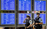 Illustrative: German police officers wearing face mask walk past a flight board in a terminal at the airport in Frankfurt, Germany, on May 11, 2021. (AP/Michael Probst)
