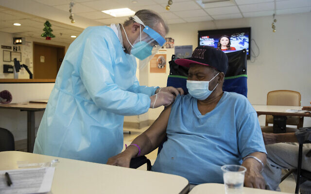 In this Jan. 15, 2021, file photo, a pharmacist administers a COVID-19 vaccine to a nursing home resident at Harlem Center for Nursing and Rehabilitation, New York (AP Photo/Yuki Iwamura, File) In this Jan. 15, 2021, file photo, a pharmacist administers a COVID-19 vaccine to a nursing home resident at Harlem Center for Nursing and Rehabilitation, New York (AP Photo/Yuki Iwamura, File)