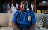 Franklin Anchahua-Herrera sits for a portrait in a room that he shares with his father, August 17, 2021, in the Queens borough of New York. (AP/John Minchillo)