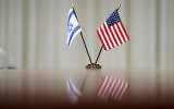 Illustrative: A flag of Israel and an American flag are displayed on a table during a meeting between Secretary of Defense Lloyd Austin and Prime Minister Naftali Bennett at the Pentagon in Washington, August 25, 2021. (AP Photo/Andrew Harnik)