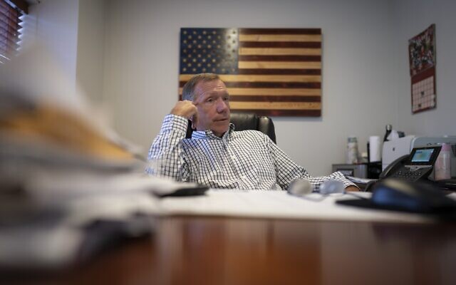 Retired NYPD Officer Ken Winkler, sits in his office on Tuesday, Aug. 3, 2021, in New York. Winkler helped coordinate the New York Police Department Emergency Service Unit response on-scene at the World Trade Center on Sept. 11, ducking behind a truck to escape the debris when the south tower collapsed. "It went from a clear day to various shades of gray and black … from kind of organized chaos to just chaos," recalls Winkler. (AP Photo/Wong Maye-E)