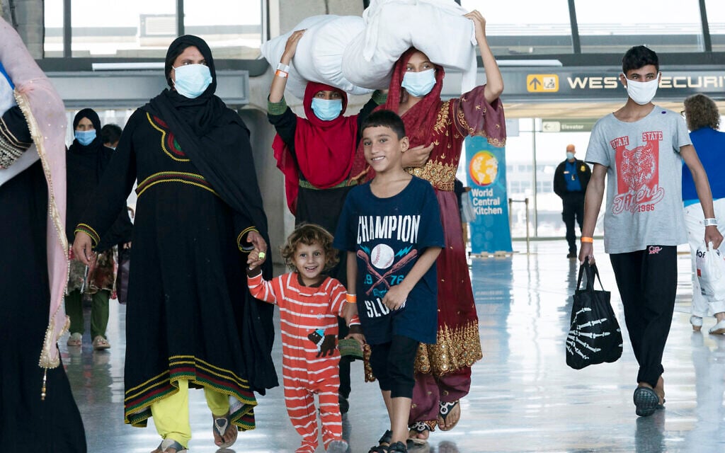 Illustrative: Families evacuated from Kabul, Afghanistan, walk through the terminal before boarding a bus after they arrived at Washington Dulles International Airport, in Chantilly, Virginia, August 30, 2021. (AP Photo/Jose Luis Magana)