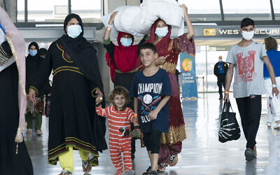 Illustrative: Families evacuated from Kabul, Afghanistan, walk through the terminal before boarding a bus after they arrived at Washington Dulles International Airport, in Chantilly, Virginia, August 30, 2021. (AP Photo/Jose Luis Magana)