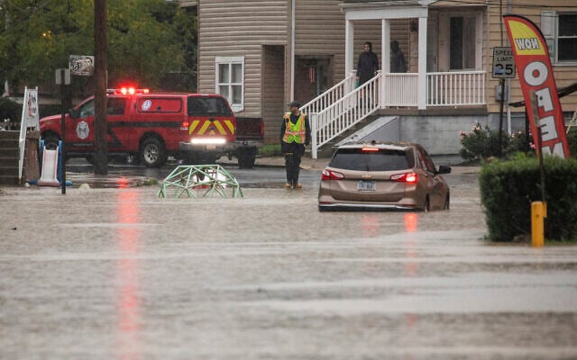 A car is stranded on a flooded street September 1, 2021, in Bridgeville, Pennsylvania. (Andrew Rush/Pittsburgh Post-Gazette via AP) A car is stranded on a flooded street September 1, 2021, in Bridgeville, Pennsylvania. (Andrew Rush/Pittsburgh Post-Gazette via AP)