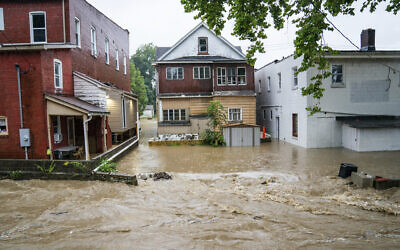 Water floods a street September 1, 2021, in Bridgeville, Pennsylvania. (Andrew Rush/Pittsburgh Post-Gazette via AP)